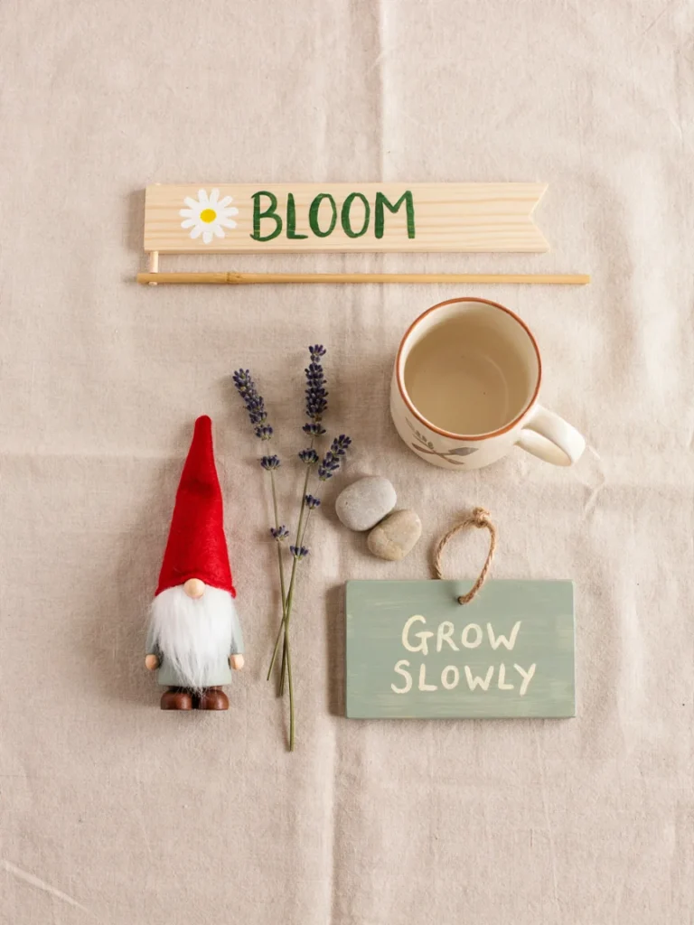 A simple, clean flat lay of several gardening gift options side by side, a flag, a mug, a small gnome, and a sign, arranged neatly to suggest comparison and choice.