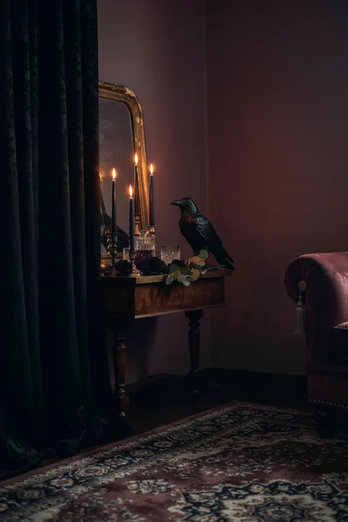 Elegant living room corner styled in deep purple and black, tall black candlesticks, raven silhouette figurine, antique frame, dramatic moody lighting, sophisticated Halloween styling