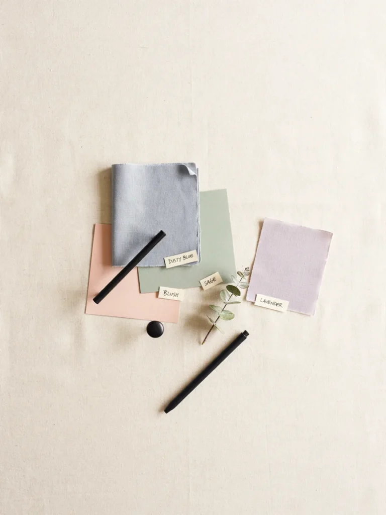 Flat lay of muted color swatches in dusty blue, sage green, warm blush, and soft lavender paired with matte black hardware, sophisticated tween appropriate color palette