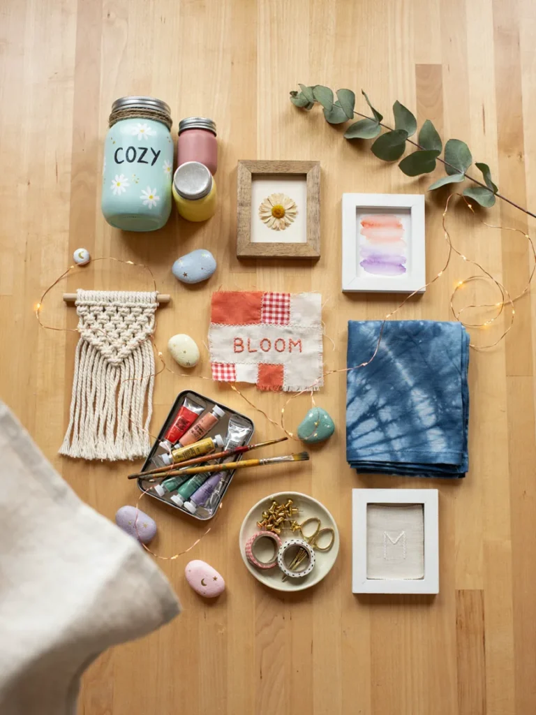 Wide flat lay overview of many small DIY bedroom decor projects arranged together, painted jars, fabric art, string lights, and small frames, colorful creative crafting layout